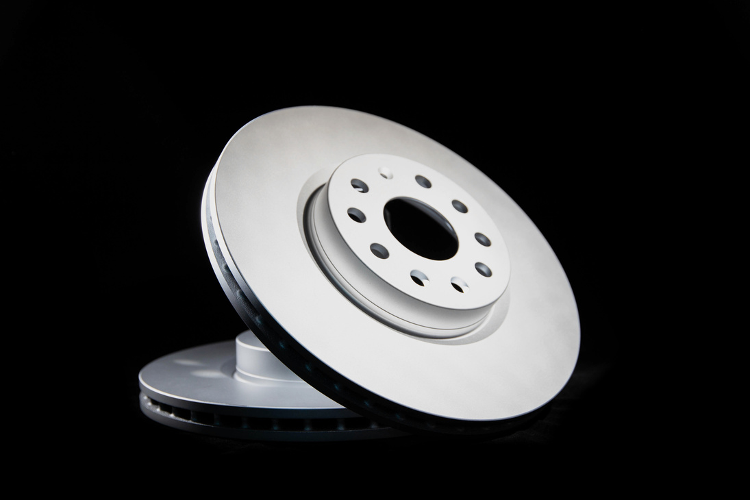 Car brake discs on a black background, isolate. Disc brake system, effective braking, close-up